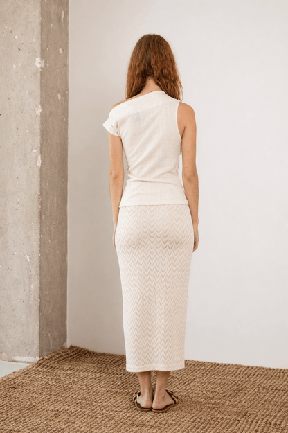 Woman wearing Banana Pineapple Drape Neckline Top in Ecru from the back, showcasing its elegant design.