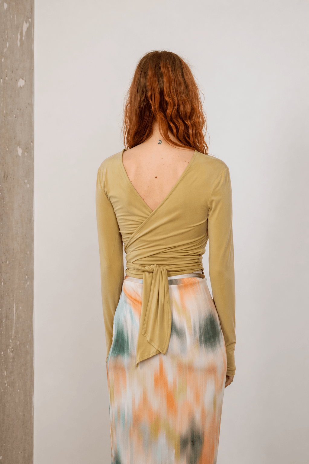 Cupro Multiway Wrap Top in Soft Olive showcasing the back design and tie detail.