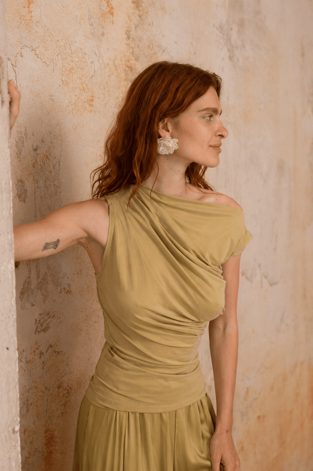 Drape Neckline Cupro Top in Soft Olive worn by model, showcasing elegant draped design and soft olive color.