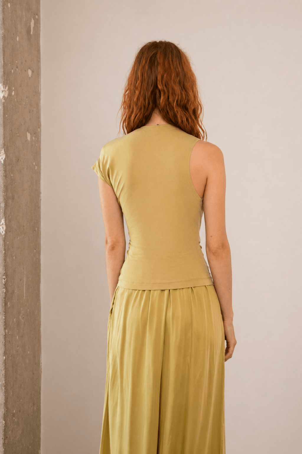 Drape Neckline Cupro Top in Soft Olive displayed from the back, highlighting its smooth jersey fabric and fitted design.