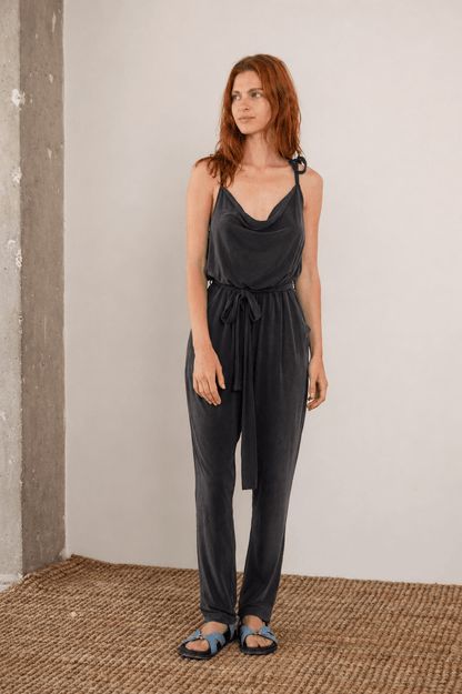 Cupro Slip Jumpsuit with Belt in Slate Black worn by model, highlighting relaxed elegance and versatile style.