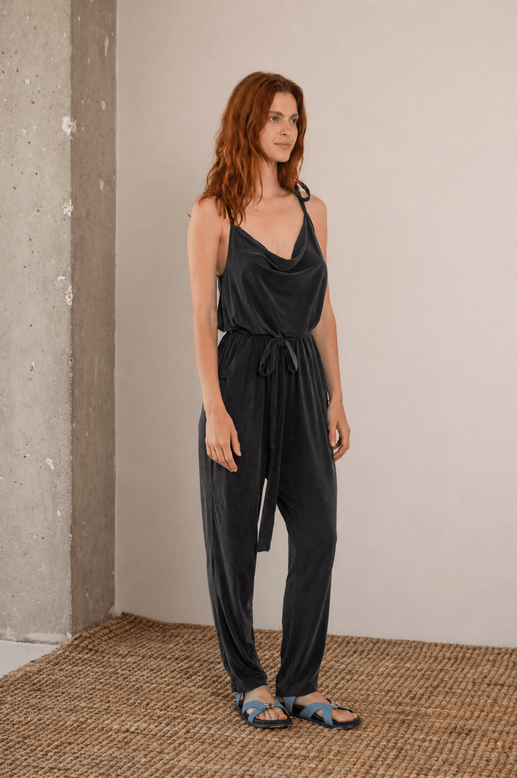 Cupro Slip Jumpsuit with Belt in Slate Black worn by a model, showcasing relaxed elegance and versatility.