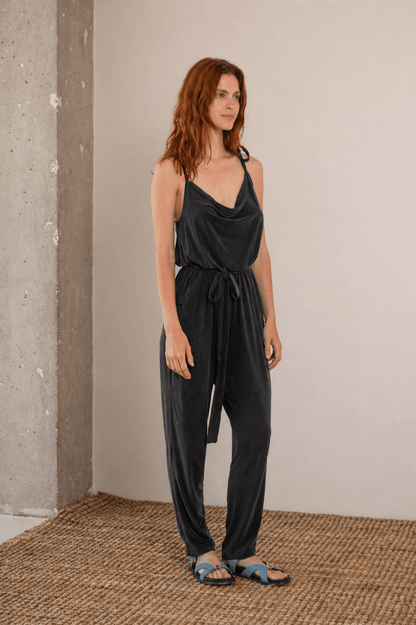 Cupro Slip Jumpsuit with Belt in Slate Black worn by a model, showcasing relaxed elegance and versatility.