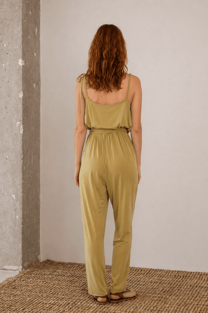 Cupro Slip Jumpsuit with Belt in Olive, showcasing the back view of a woman wearing a stylish olive jumpsuit.