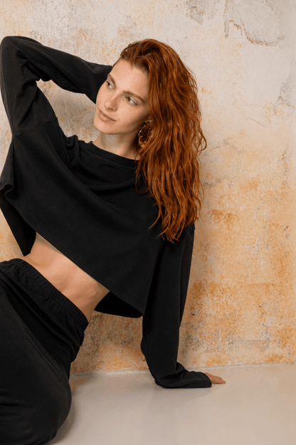Organic Cotton Long Sleeve Top in Black, styled with relaxed fit and cropped silhouette, ideal for warm weather.