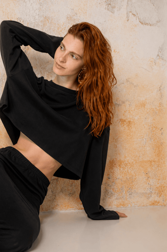 Organic Cotton Long Sleeve Top in Black, styled with relaxed fit and cropped silhouette, ideal for warm weather.