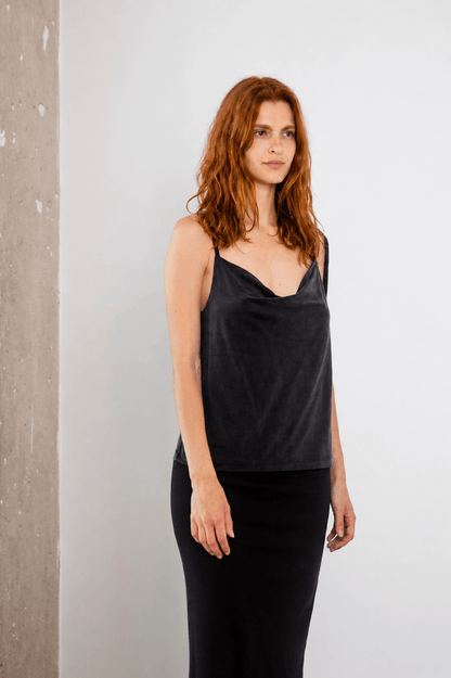 Cupro Drape Slip Top in Slate Black worn by a model, showcasing its elegant draped neckline and adjustable straps.