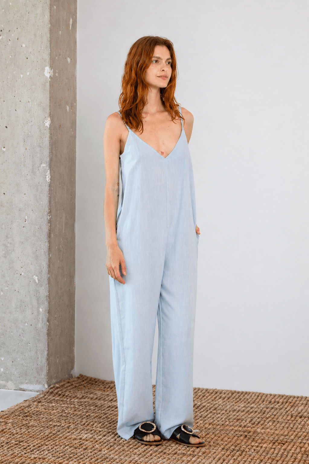 Organic Cotton Wide Jumpsuit in Pale Blue worn by a model, showcasing the relaxed fit and soft fabric ideal for warm weather.