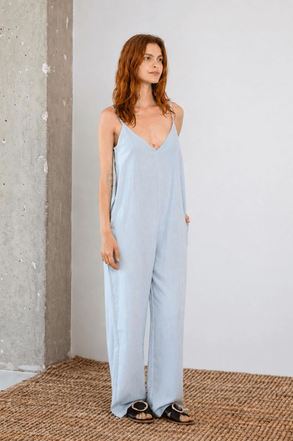 Organic Cotton Wide Jumpsuit in Pale Blue worn by a model, showcasing the relaxed fit and soft fabric ideal for warm weather.