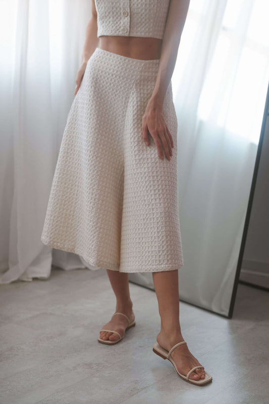 Ecru waffle skirt culottes with a high waist, side pockets, and a stylish A-line silhouette, perfect for versatile outfits.