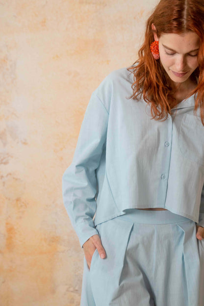 Cropped Organic Cotton Shirt in Pale Blue worn by a model with a relaxed look and stylish design.