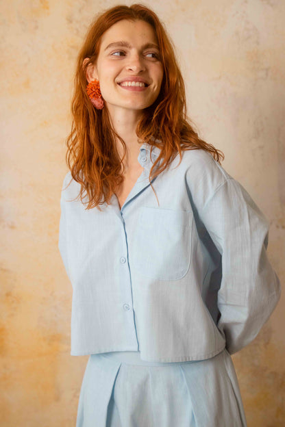 Cropped Organic Cotton Shirt in Pale Blue worn by model, showcasing relaxed fit and breathable style.