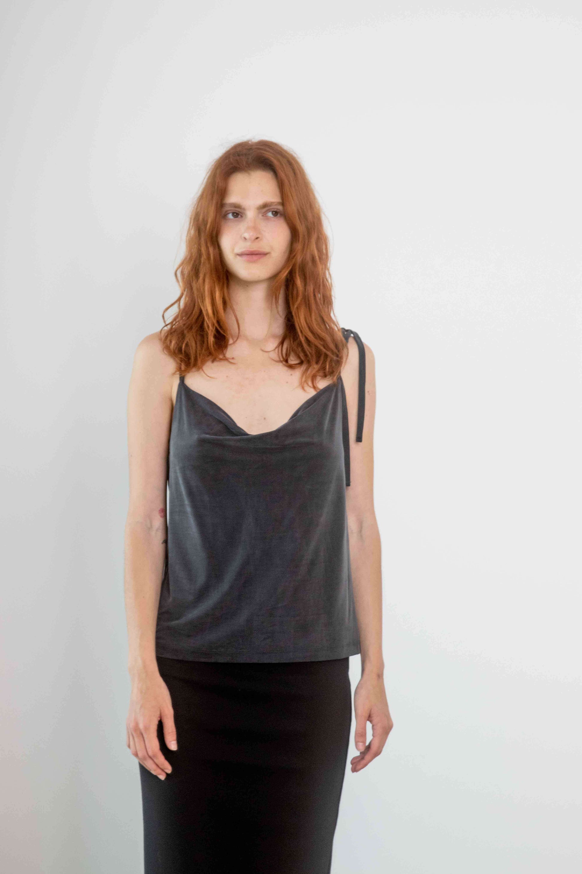 Model wearing Cupro Drape Slip Top in Slate Black, showcasing a flattering draped neckline and adjustable straps.