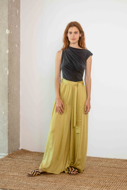 Drape Neckline Bodysuit in Slate Black worn with flowy, high-waisted yellow trousers.