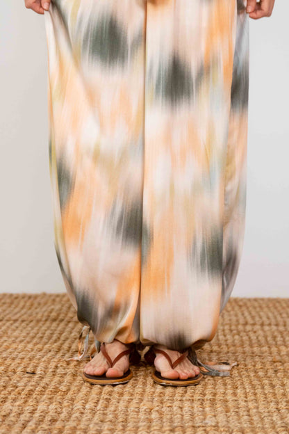 Printed Ecovero Viscose Wide-Leg Trousers featuring a colorful, fluid design and relaxed fit, styled with sandals.