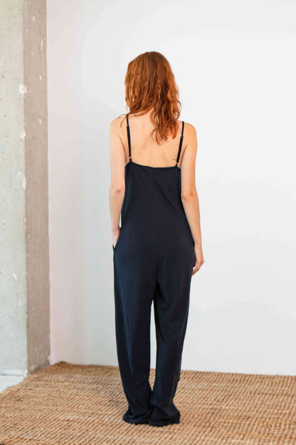 Organic Cotton Wide Jumpsuit in Black, back view showcasing relaxed fit and slim straps.