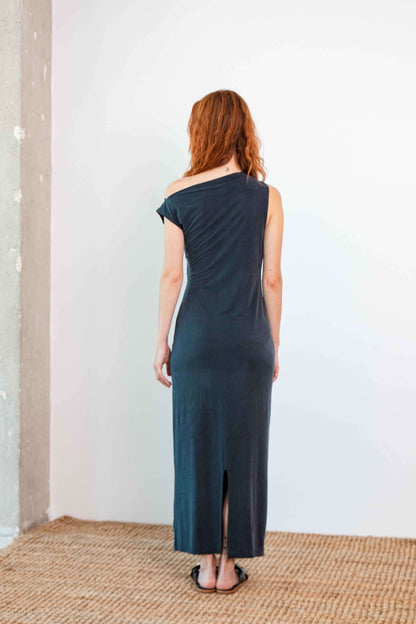 Model showcasing the back of the Drape Cupro Midi Dress in Slate Black against a simple background.