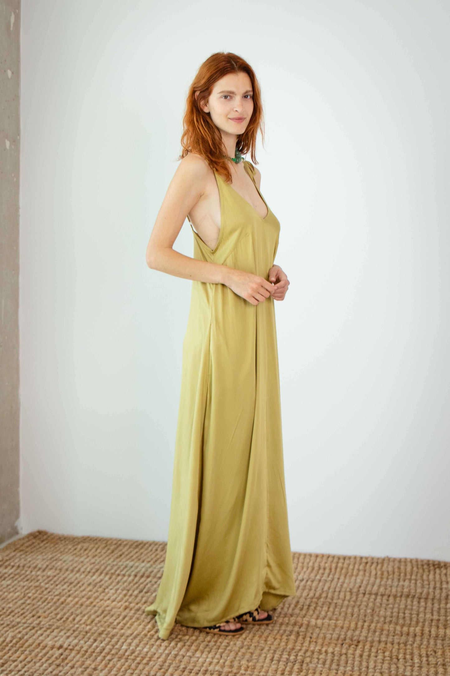Model wearing Ecovero Maxi Dress in soft olive color, showcasing its fluid and lightweight design.