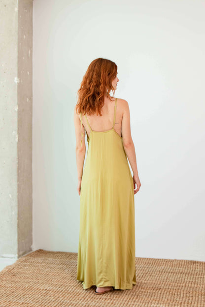 Ecovero Maxi Dress shown in soft olive, featuring adjustable straps and a lightweight flowy design.