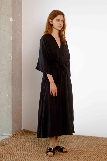 Tencel Kimono Jumpsuit in Black worn by a model, showcasing its relaxed silhouette and elegant design.