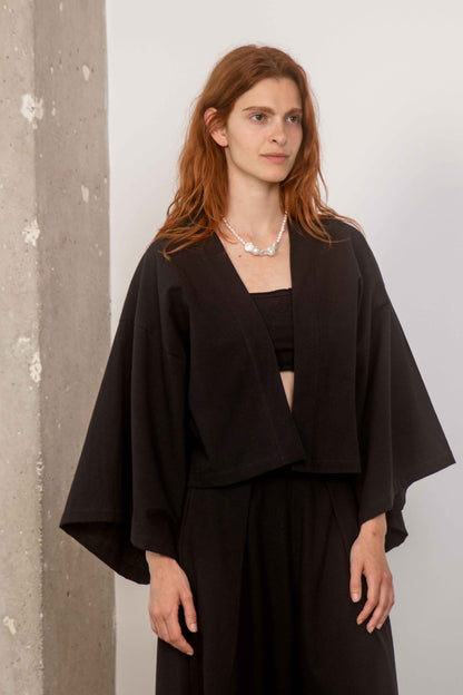 Model wearing Organic Cotton Kimono Jacket, showcasing its oversized design and relaxed silhouette.