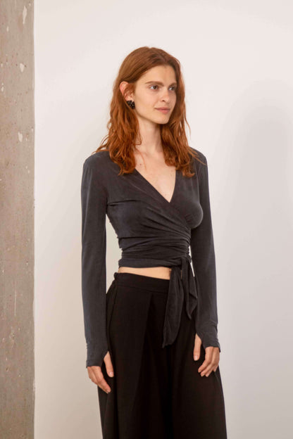 Model wearing a Cupro Multiway Wrap Top  in Slate Black, showcasing its versatile wrap design and elegant fit.