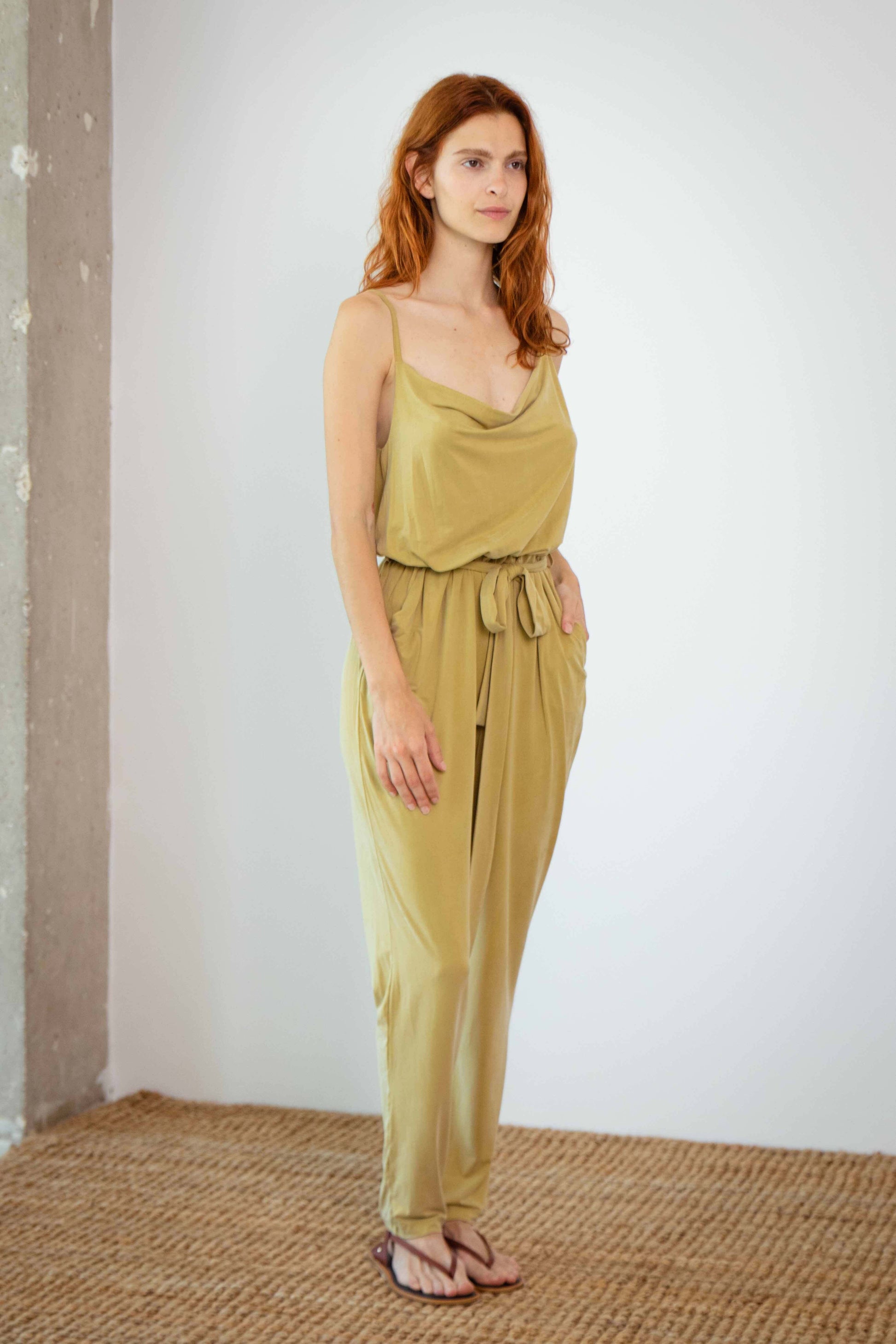 Cupro Slip Jumpsuit in olive, featuring slim cami straps and a detachable belt for a stylish, relaxed look.