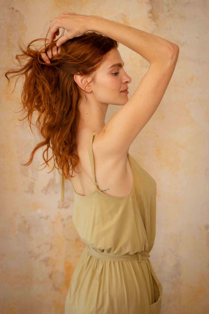 Model showcasing the Cupro Slip Jumpsuit with Belt in Olive, exuding elegance and style.