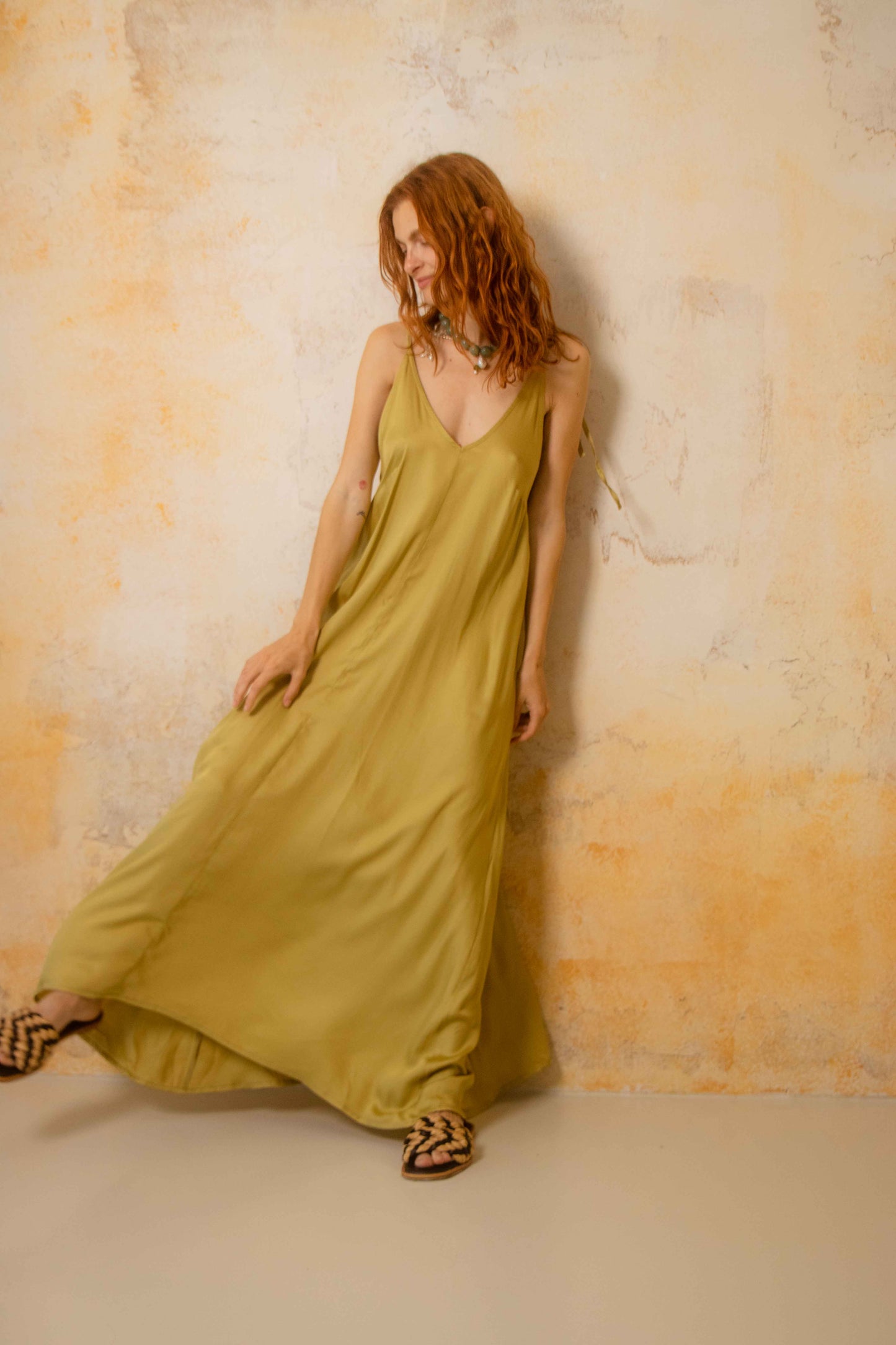 Model wearing Ecovero Maxi Dress in soft olive color, showcasing lightweight and flowing design.