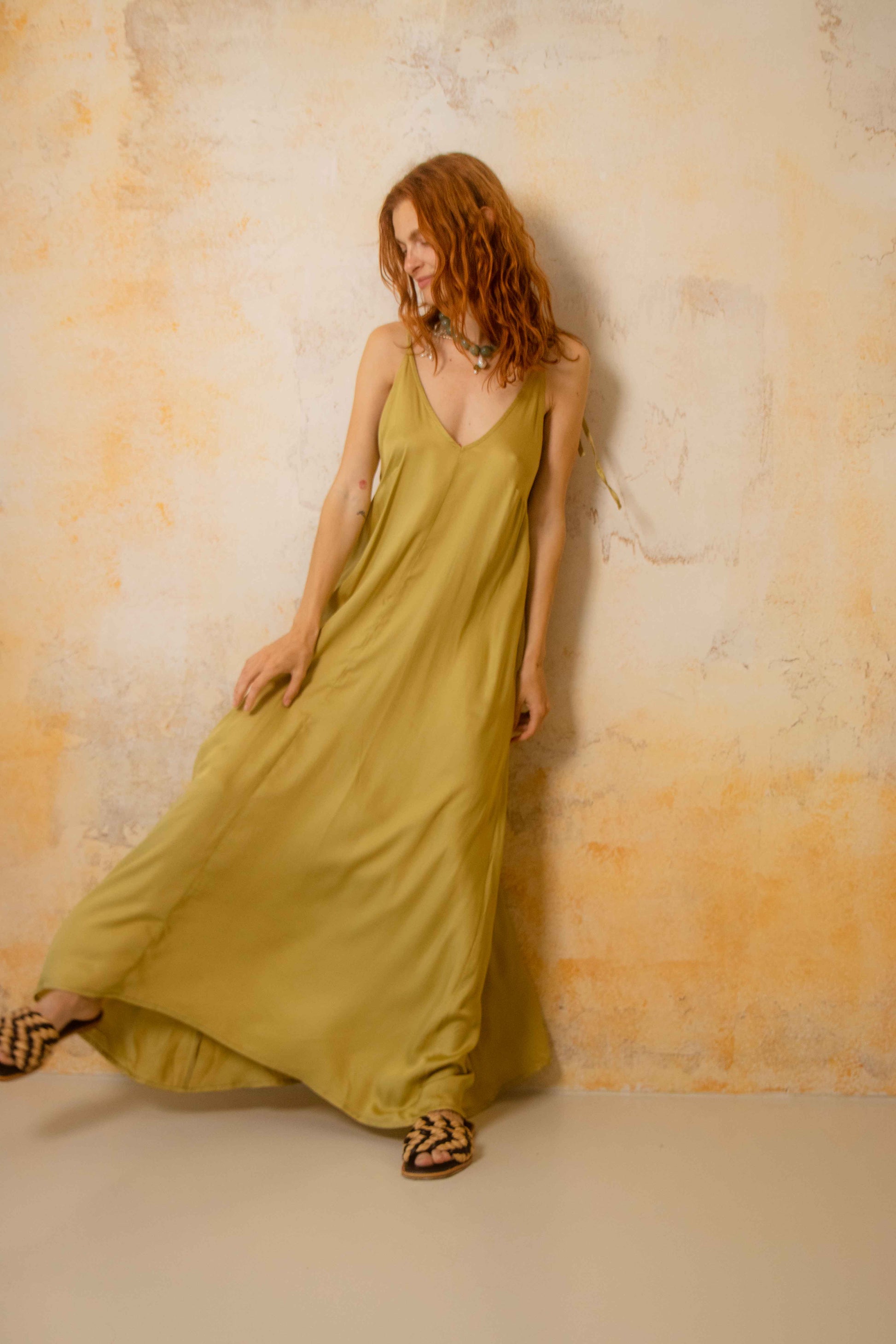 Model wearing Ecovero Maxi Dress in soft olive color, showcasing lightweight and flowing design.