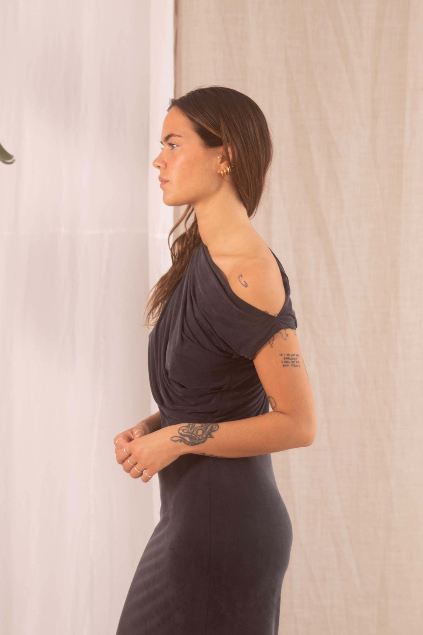 Model showcasing the Drape Cupro Midi Dress in Slate Black, featuring a draped neckline and smooth cupro fabric.