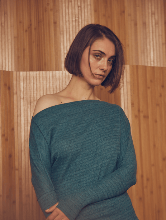 Model wearing a Teal Drape Top with drape neckline, made from organic cotton and wool.