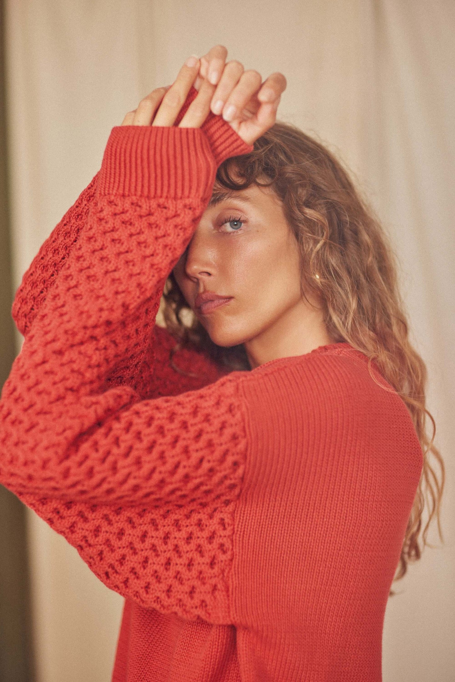 Model wearing a Heavy Knit Rust Vegan Sweater with unique fantasy sleeves, showcasing its soft and breathable design.