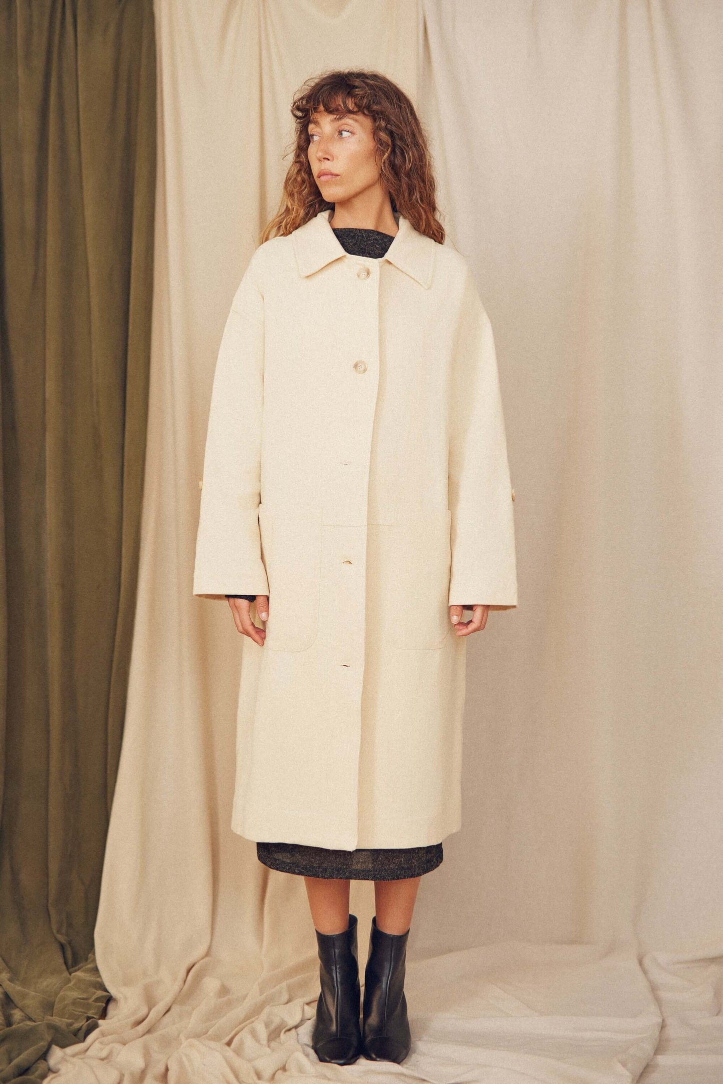 Woman wearing a oat wide coat.