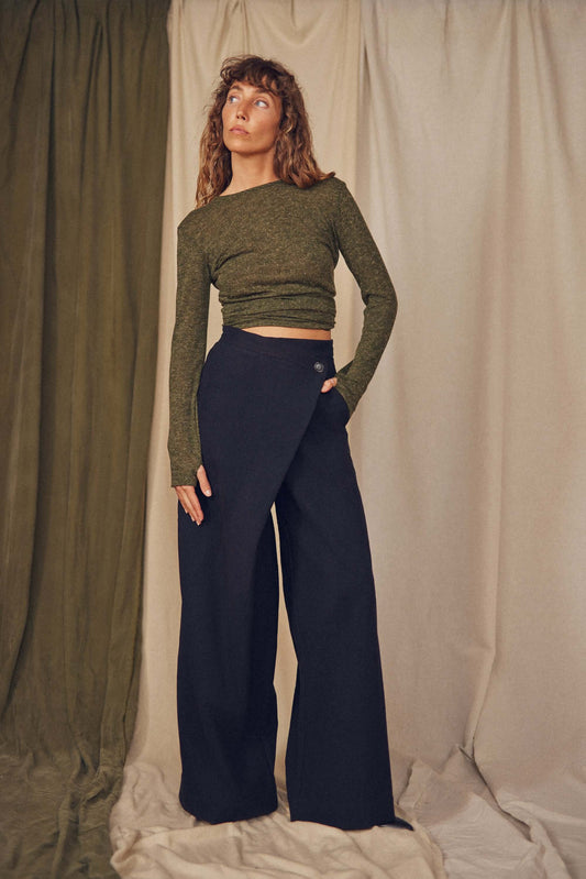 Woman wearing black wrap trousers.