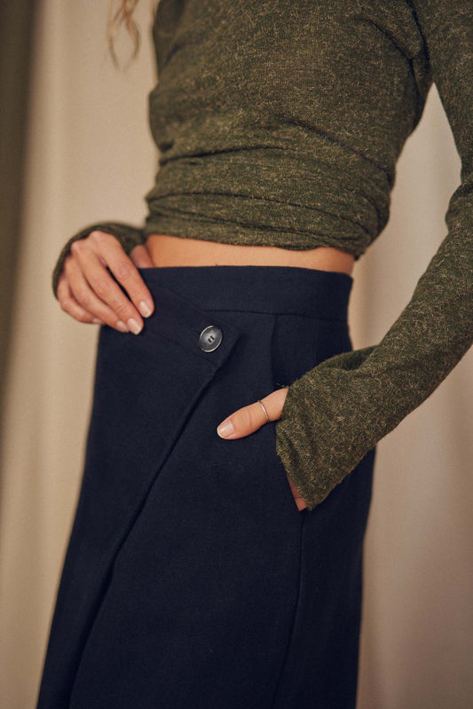 Woman wearing black wrap trousers.