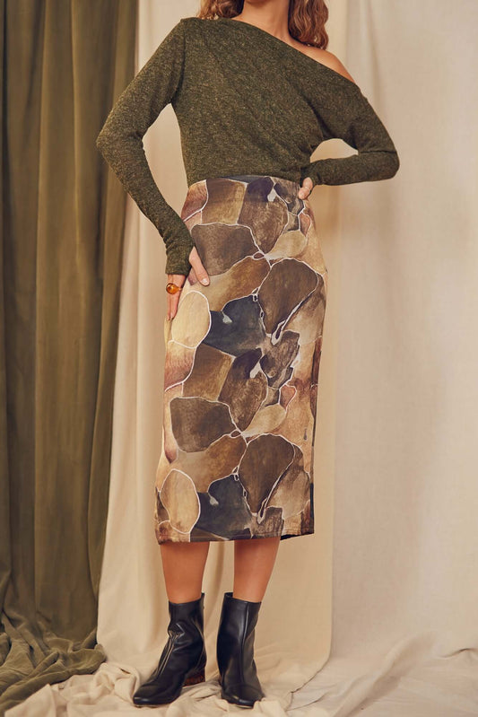 Model wearing Printed Ecovero Pencil Midi Skirt paired with a green off-shoulder top and ankle boots.