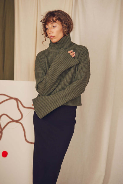 Khaki Heavy Knitted Wool Sweater featuring a ribbed texture and cozy turtleneck design, perfect for autumn layering.