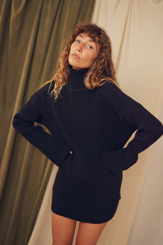 Model wearing a Black Heavy Knitted Wool Tunic featuring relaxed fit and ribbed texture.