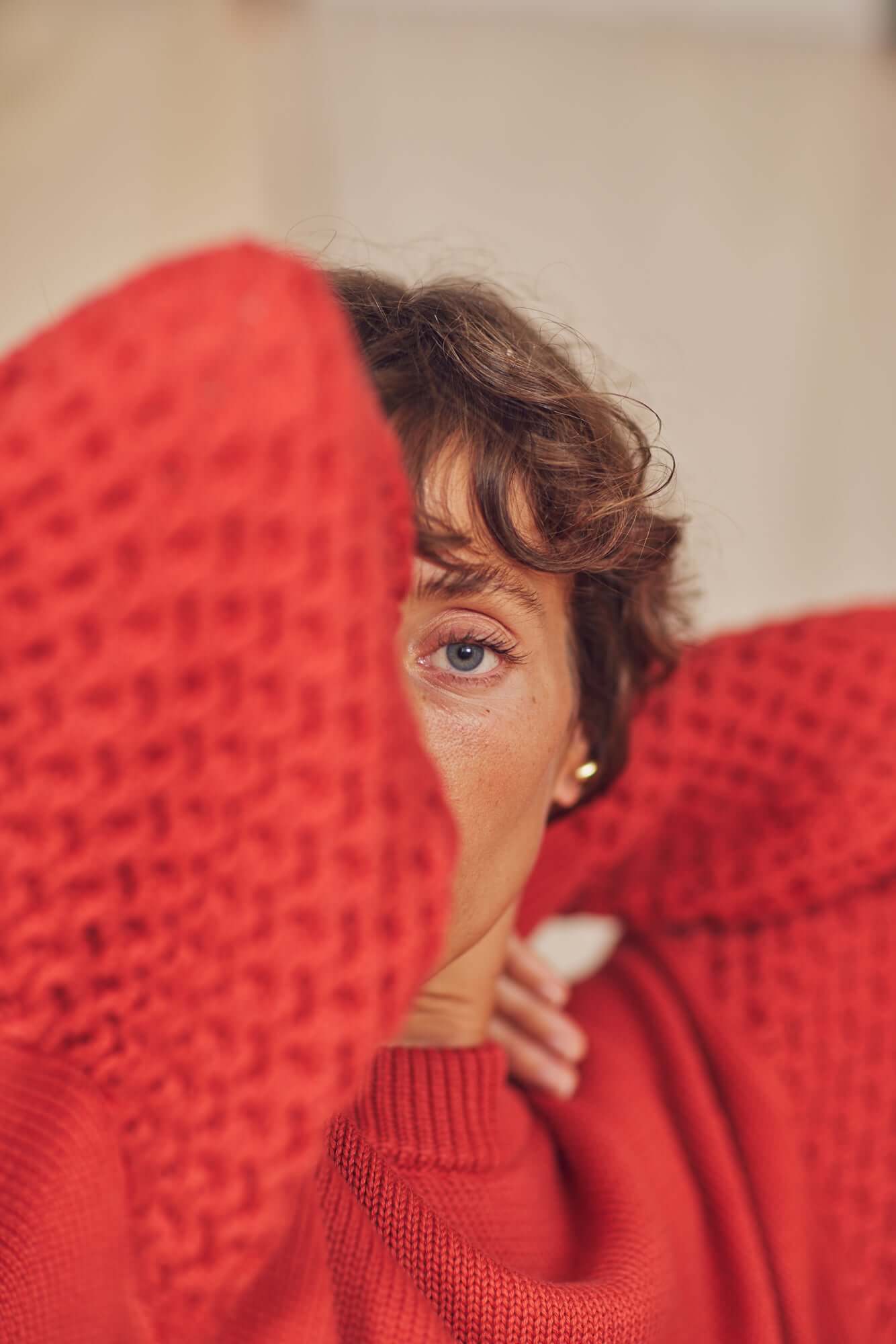 Model wearing a Heavy Knit Rust Vegan Sweater, showcasing a unique fantasy sleeve and warm autumn vibe.