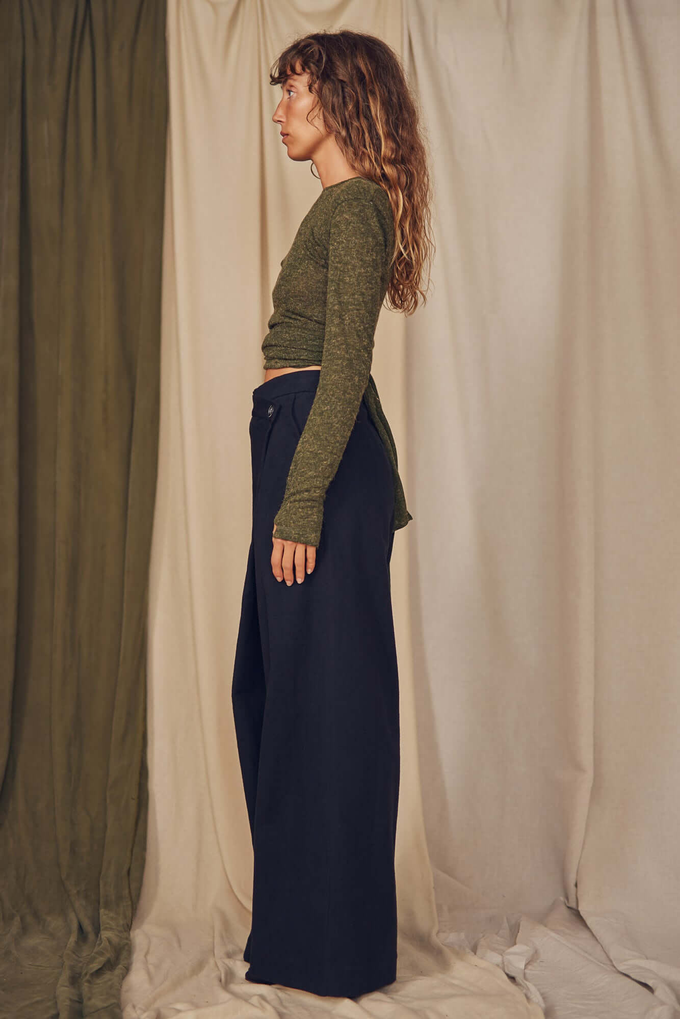Woman wearing black wrap trousers.