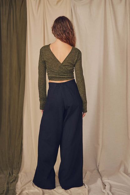 Woman wearing black wrap trousers.