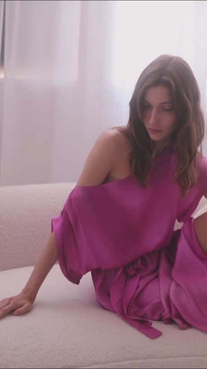 Model wearing a stylish off-shoulder pink printed midi dress, showcasing its soft, breathable Ecovero viscose fabric.