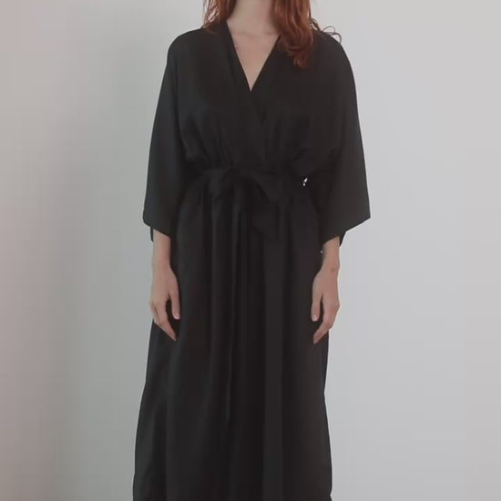 Kimono Tencel Jumpsuit in Black worn by a model, showcasing its modern relaxed silhouette and elegance.