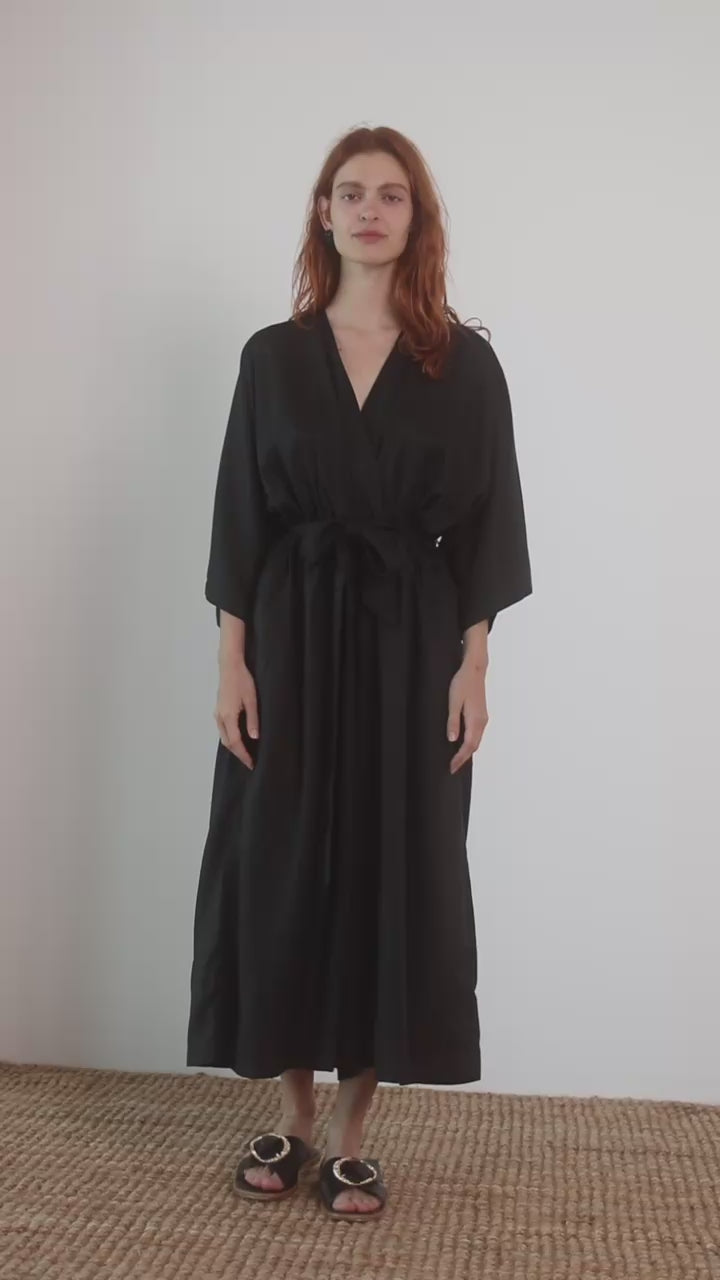 Kimono Tencel Jumpsuit in Black worn by a model, showcasing its modern relaxed silhouette and elegance.