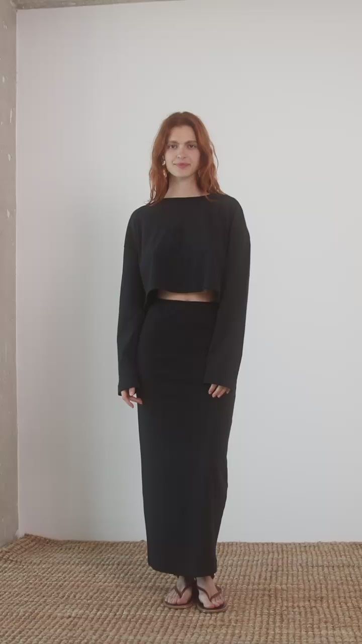 Model wearing Organic Cotton Midi Pencil Skirt in Black paired with a matching top, showcasing a stylish outfit.