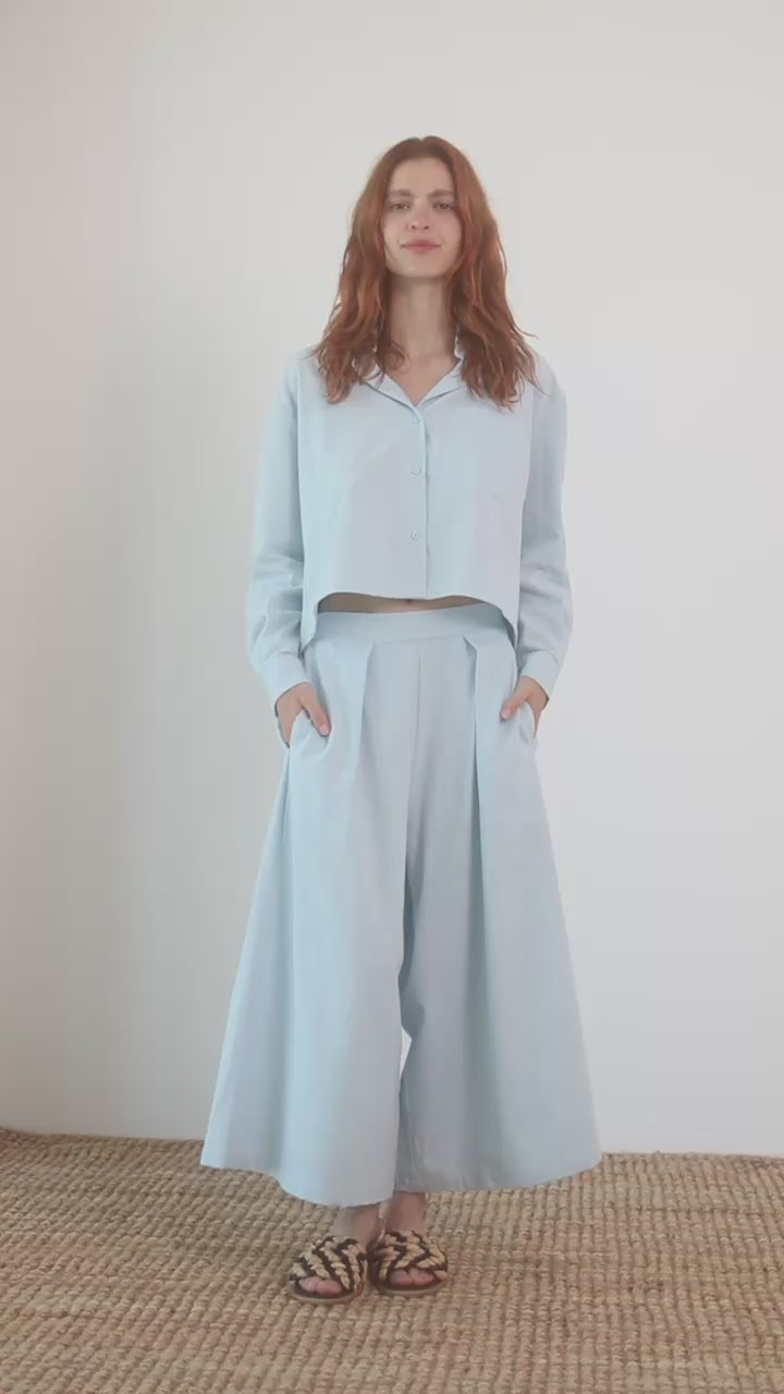 Model wearing Wide Culottes in Organic Cotton in Pale Blue with a matching cropped shirt.