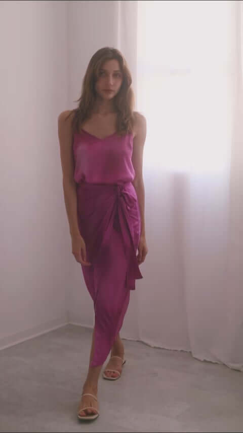 Model wearing a pink print wrap midi skirt and matching top, showcasing versatile styling options and elegant fashion.