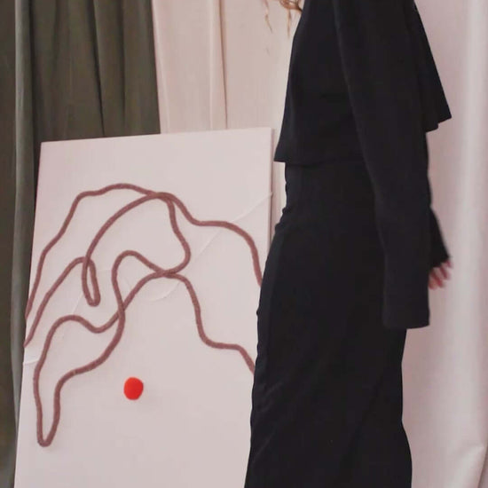 Model wearing a black organic cotton long sleeve crop top with a skirt, showcasing minimalist style and eco-friendly fashion.