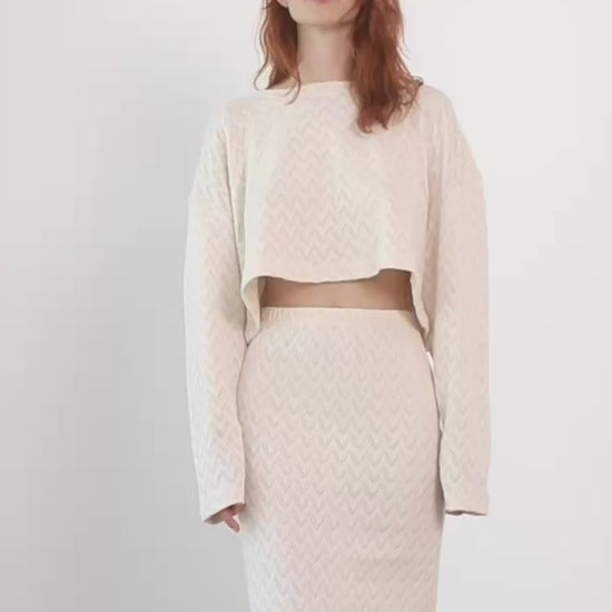 Model wearing a Crochet Organic Cotton Long Sleeve Top with a matching skirt in ecru color.